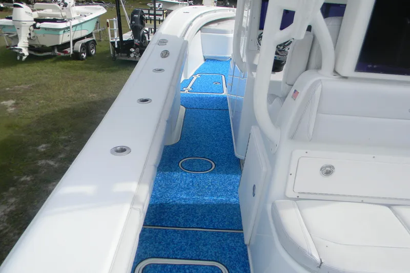 Slide: The Image of 2017 Yellowfin 32 Offshore boat interior with blue flooring and white seating. - 11
