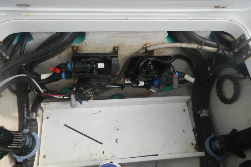 Slide: The Image of 2017 Yellowfin 32 Offshore boat wiring and pump system in compartment. - 12