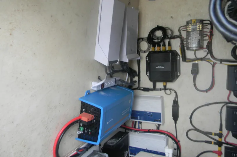 Slide: The Image of Electrical components inside a 2017 Yellowfin 32 Offshore boat, featuring wiring and devices. - 20