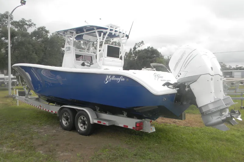 Slide: The Image of 2017 Yellowfin 32 Offshore boat on trailer, featuring blue hull and twin Mercury engines. - 4