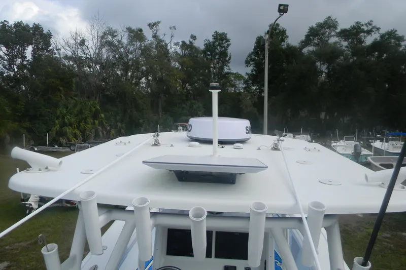 Slide: The Image of 2017 Yellowfin 32 Offshore boat roof with radar and antenna, surrounded by trees. - 6