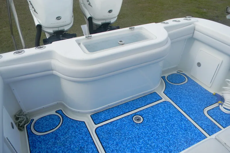 Slide: The Image of 2017 Yellowfin 32 Offshore boat deck with blue flooring and twin outboard engines. - 8
