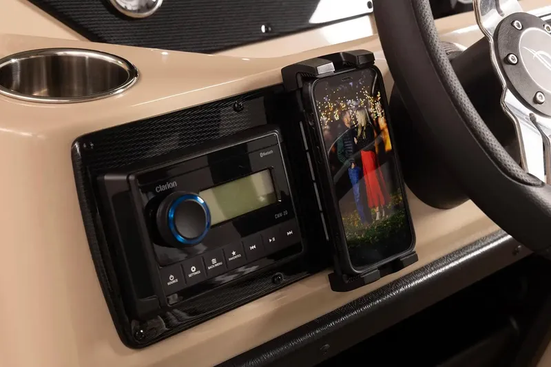 Slide: The Image of 2024 SunCatcher Select 322RC dashboard with Bluetooth stereo and smartphone holder. - 11