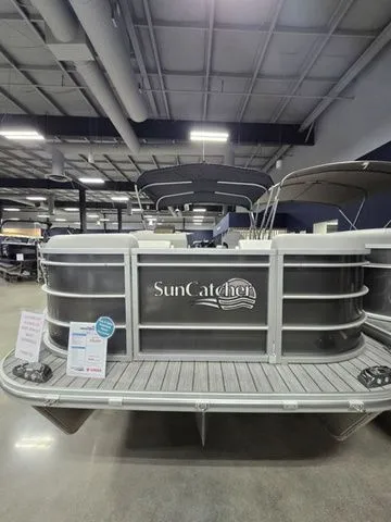 Slide: The Image of 2024 SunCatcher Select 322RC pontoon boat displayed indoors, showcasing sleek design and modern features. - 2