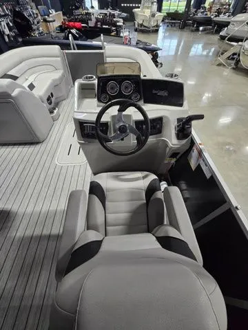 Slide: The Image of 2024 SunCatcher Select 322RC boat interior with steering wheel and seating. - 7