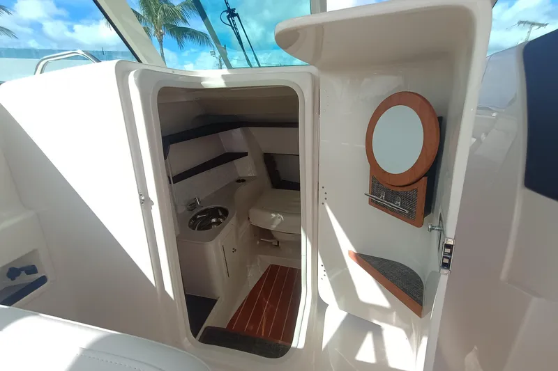 Slide: The Image of 2026 Grady-White Freedom 325 boat interior with sink and mirror, showcasing luxury design. - 25