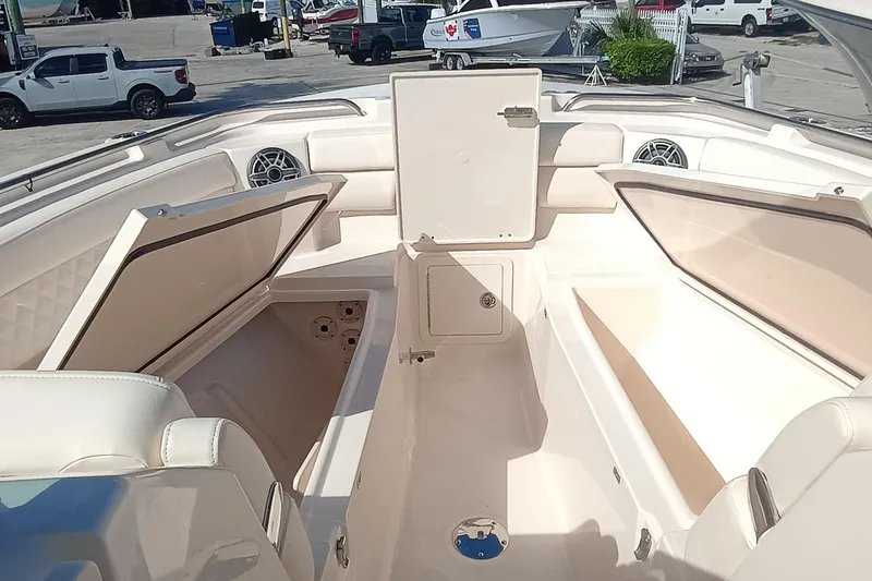 Slide: The Image of 2026 Grady-White Freedom 325 boat interior with open storage compartments and seating. - 30