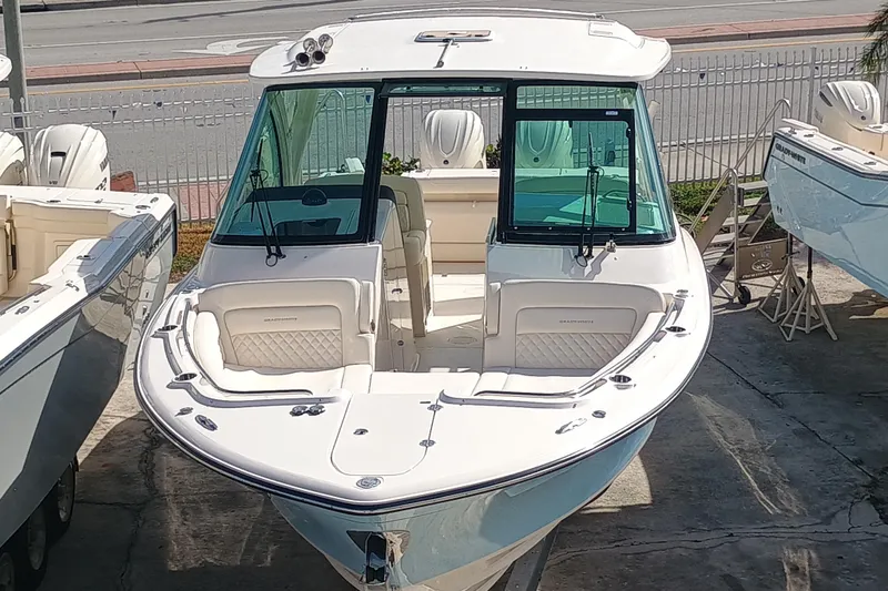 Slide: The Image of 2026 Grady-White Freedom 325 boat displayed in a marina setting. - 7