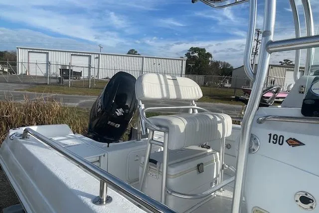 Slide: The Image of 2011 Triumph 190 Bay boat with seating and motor, parked outdoors. - 16