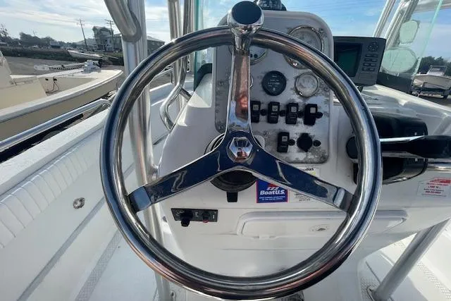 Slide: The Image of Steering wheel of a 2011 Triumph 190 Bay boat, showcasing dashboard controls. - 5