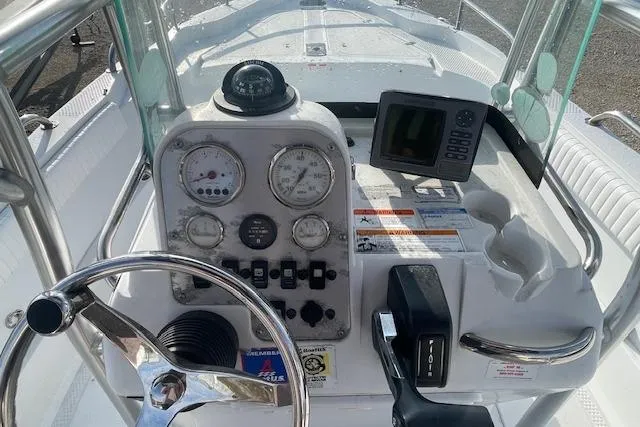 Slide: The Image of 2011 Triumph 190 Bay boat dashboard with steering wheel and navigation instruments. - 7