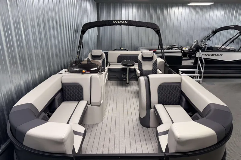 Slide: The Image of 2026 Sylvan L3 CLZ DH pontoon boat with luxurious seating in a showroom. - 1