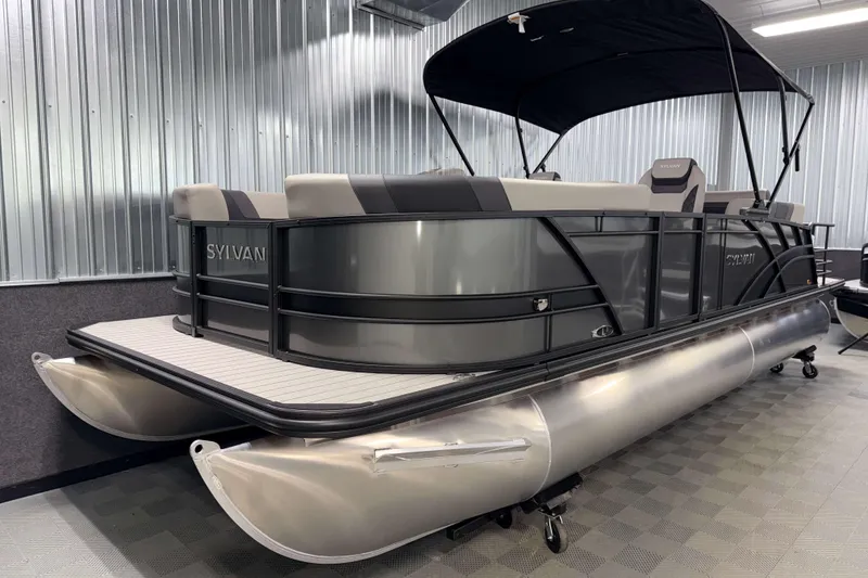 Slide: The Image of 2026 Sylvan L3 CLZ DH pontoon boat in showroom, featuring sleek design and modern seating. - 18