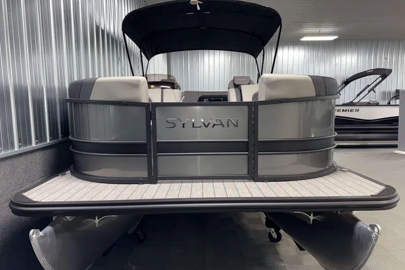 Slide: The Image of 2026 Sylvan L3 CLZ DH pontoon boat in showroom, featuring sleek design and modern seating. - 19
