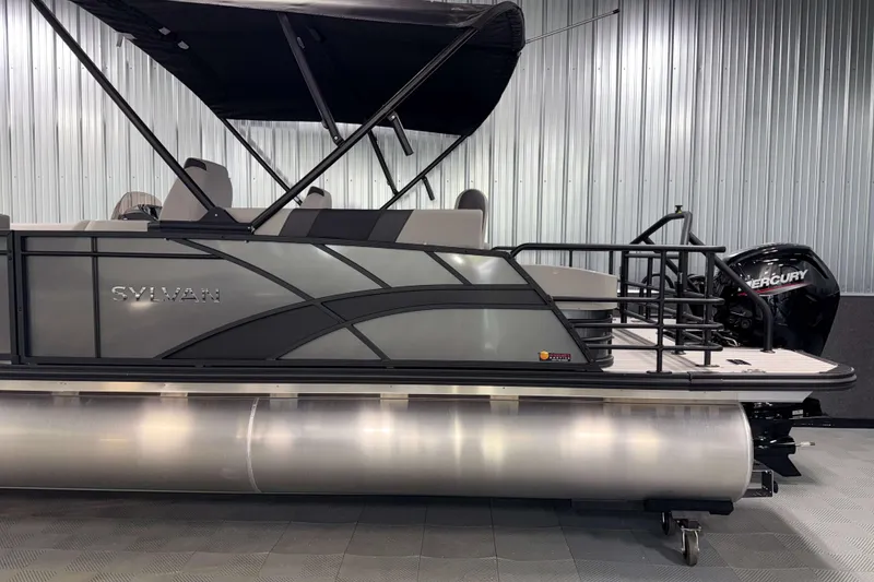 Slide: The Image of 2026 Sylvan L3 CLZ DH pontoon boat with Mercury outboard motor in showroom. - 21