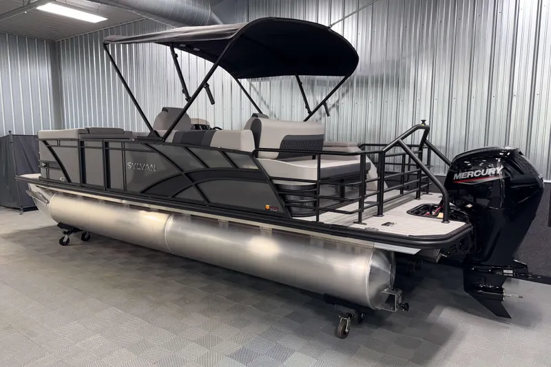 Slide: The Image of 2026 Sylvan L3 CLZ DH pontoon boat with Mercury outboard in a metal-walled showroom. - 23