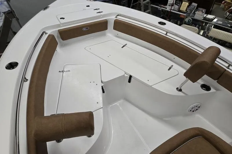 Slide: The Image of 2025 Sea Hunt Ultra 229 boat interior with cushioned seating and storage compartments. - 12