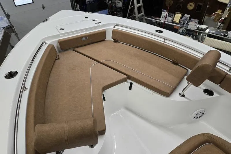 Slide: The Image of 2025 Sea Hunt Ultra 229 boat interior with tan cushioned seating. - 13