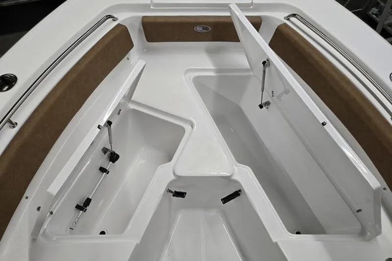 Slide: The Image of 2025 Sea Hunt Ultra 229 boat interior with open storage compartments and cushioned seating. - 15