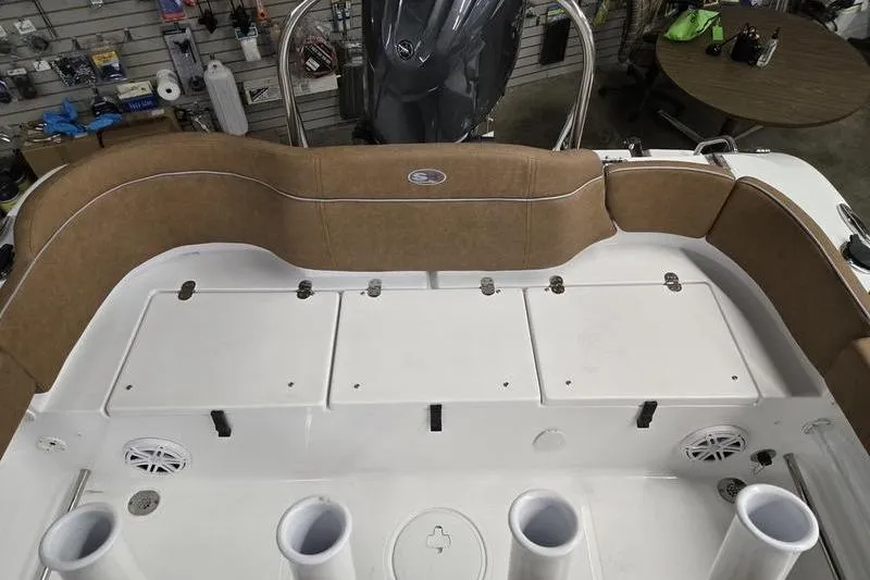 Slide: The Image of 2025 Sea Hunt Ultra 229 boat interior with cushioned seating and storage compartments. - 16