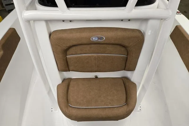 Slide: The Image of 2025 Sea Hunt Ultra 229 boat seat with brown upholstery and white frame. - 18