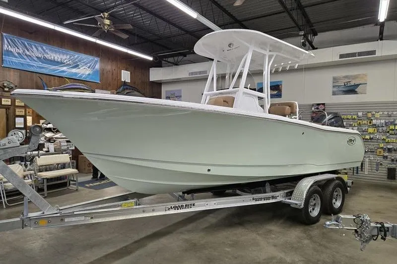 Slide: The Image of 2025 Sea Hunt Ultra 229 boat on trailer in showroom. - 19