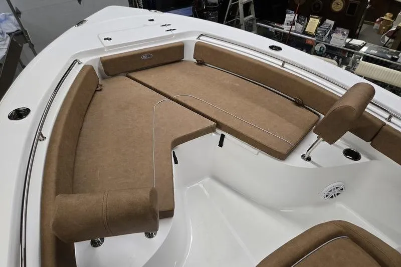 Slide: The Image of 2025 Sea Hunt Ultra 229 boat interior with cushioned seating and stainless steel railings. - 6