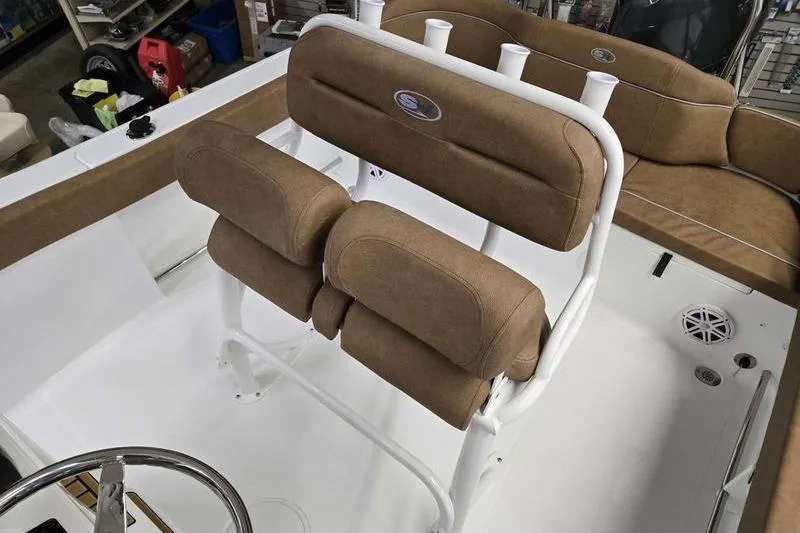 Slide: The Image of 2025 Sea Hunt Ultra 229 boat interior with cushioned seating and rod holders. - 9