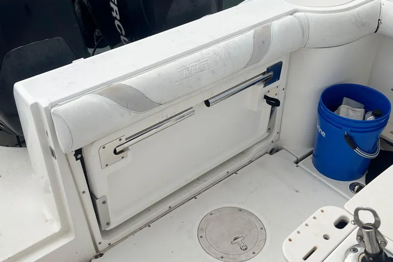 Slide: The Image of 2006 Boston Whaler 240 Outrage boat interior with seating and storage area. - 11