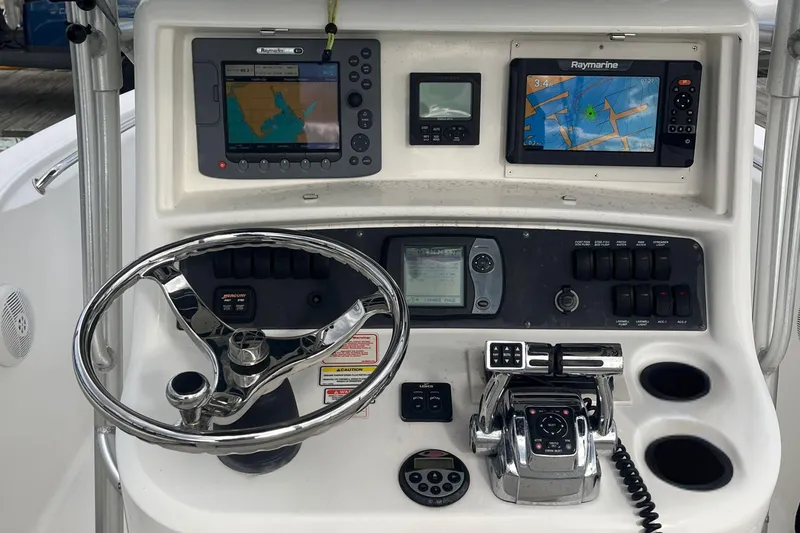 Slide: The Image of Control panel of a 2006 Boston Whaler 240 Outrage with navigation equipment. - 13