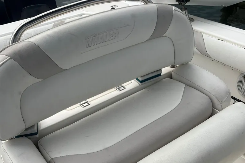 Slide: The Image of Boston Whaler 240 Outrage 2006 boat seating with embossed logo, white upholstery. - 14