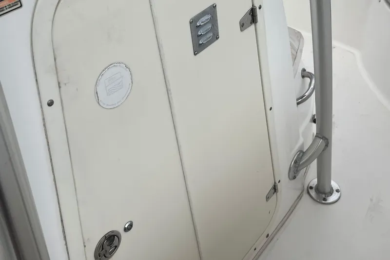 Slide: The Image of 2006 Boston Whaler 240 Outrage boat interior with door and metal railing. - 19
