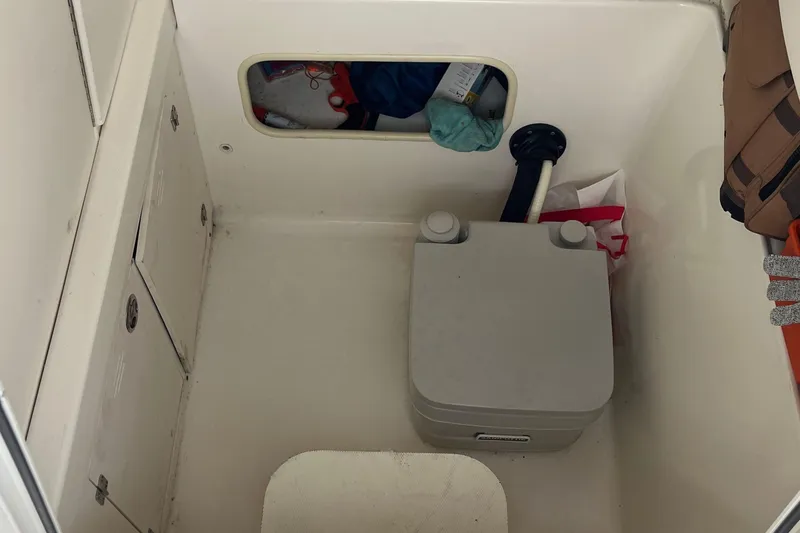 Slide: The Image of Interior of a 2006 Boston Whaler 240 Outrage boat with storage compartment. - 20