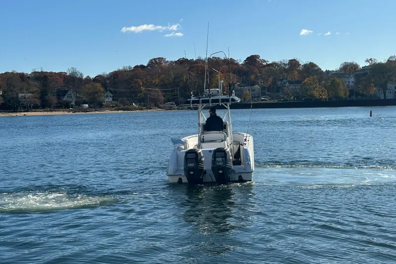 Slide: The Image of 2006 Boston Whaler 240 Outrage boat cruising on a calm lake with autumn trees. - 5