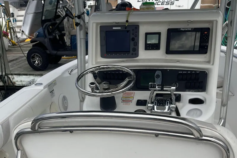 Slide: The Image of 2006 Boston Whaler 240 Outrage boat console with steering wheel and navigation equipment. - 9