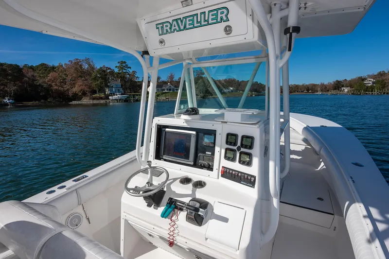Slide: The Image of 2008 Regulator 32 Forward Seating boat with modern dashboard on calm water. - 12