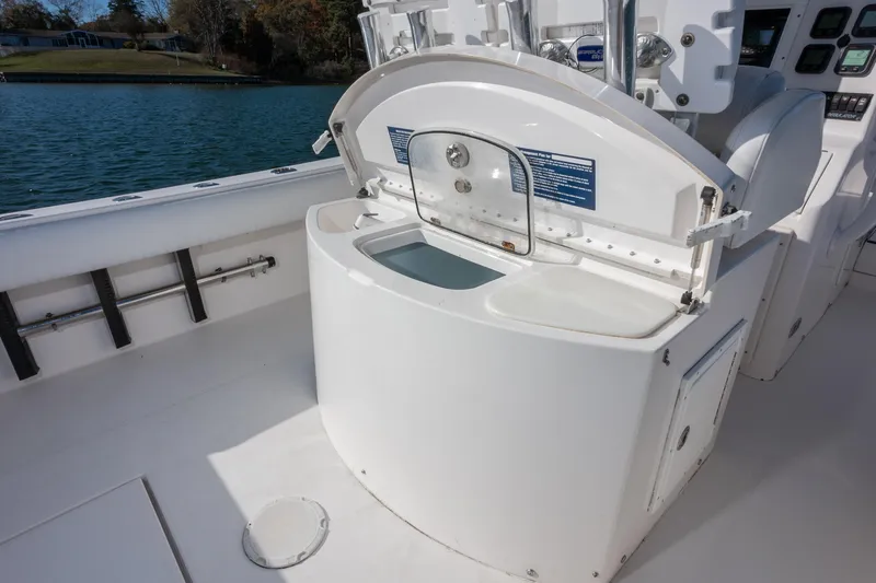 Slide: The Image of 2008 Regulator 32 Forward Seating boat interior with open storage compartment. - 14