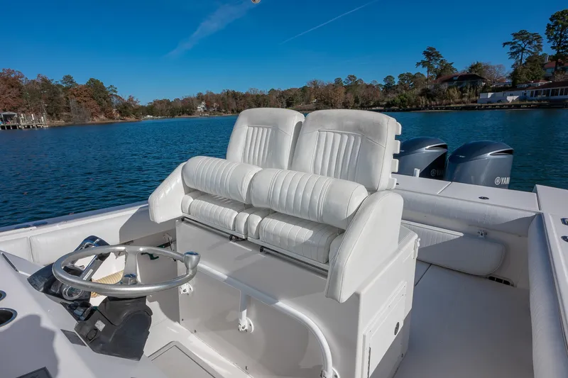 Slide: The Image of 2008 Regulator 32 Forward Seating boat with dual engines on a serene lake. - 15