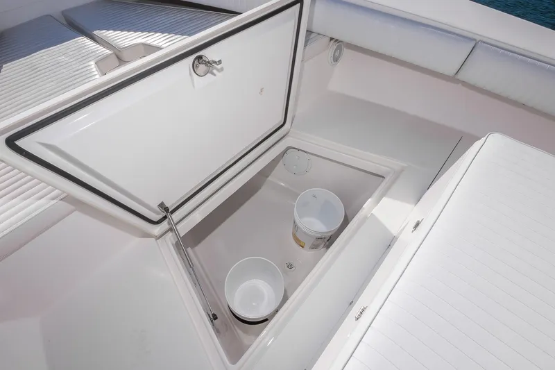 Slide: The Image of Open storage compartment on 2008 Regulator 32 Forward Seating boat with buckets inside. - 21