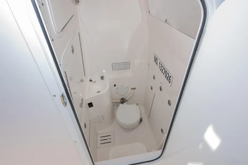 Slide: The Image of 2008 Regulator 32 Forward Seating boat interior bathroom with toilet and sink. - 24