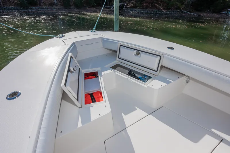 Slide: The Image of 2008 Regulator 32 Forward Seating boat with open storage compartments on deck. - 27