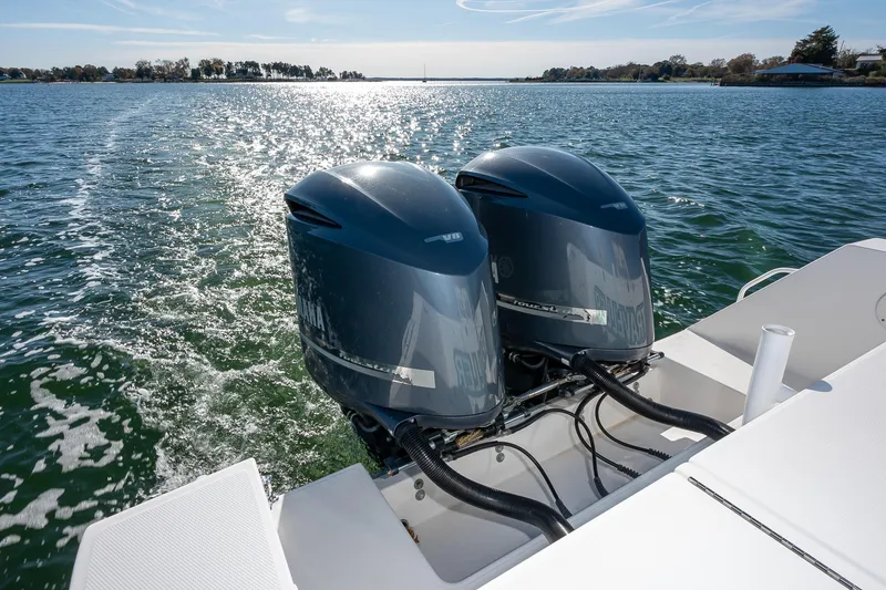 Slide: The Image of Twin outboard engines on a 2008 Regulator 32 Forward Seating boat in open water. - 28