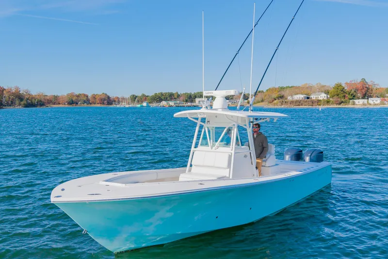 Slide: The Image of 2008 Regulator 32 Forward Seating boat on calm water with scenic shoreline. - 3