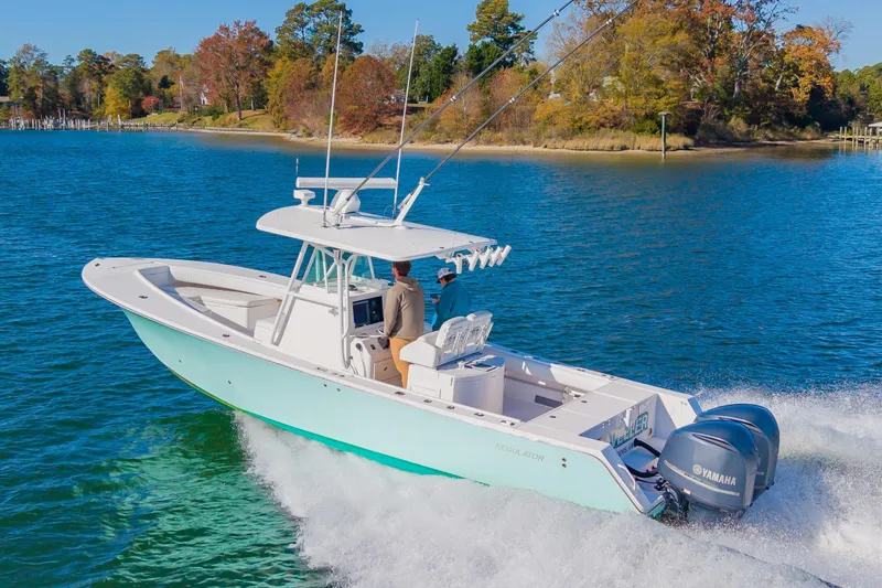 Slide: The Image of 2008 Regulator 32 Forward Seating boat cruising on a scenic lake with Yamaha engines. - 5