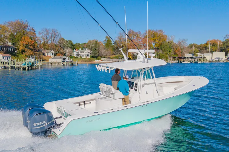 Slide: The Image of 2008 Regulator 32 Forward Seating boat cruising on a scenic lake. - 7