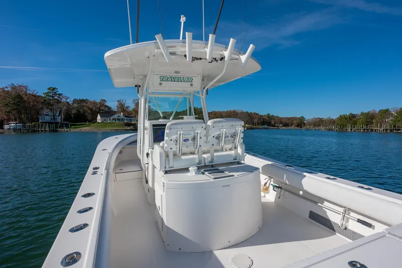 Slide: The Image of 2008 Regulator 32 Forward Seating boat on calm water, clear sky background. - 9
