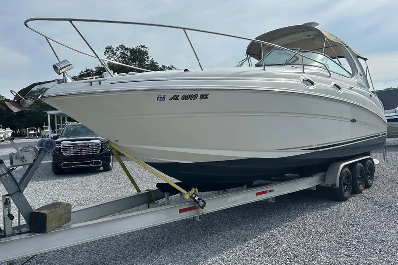 The Image of 2004 Sea Ray 280 Sundancer boat on trailer in parking lot. - 0