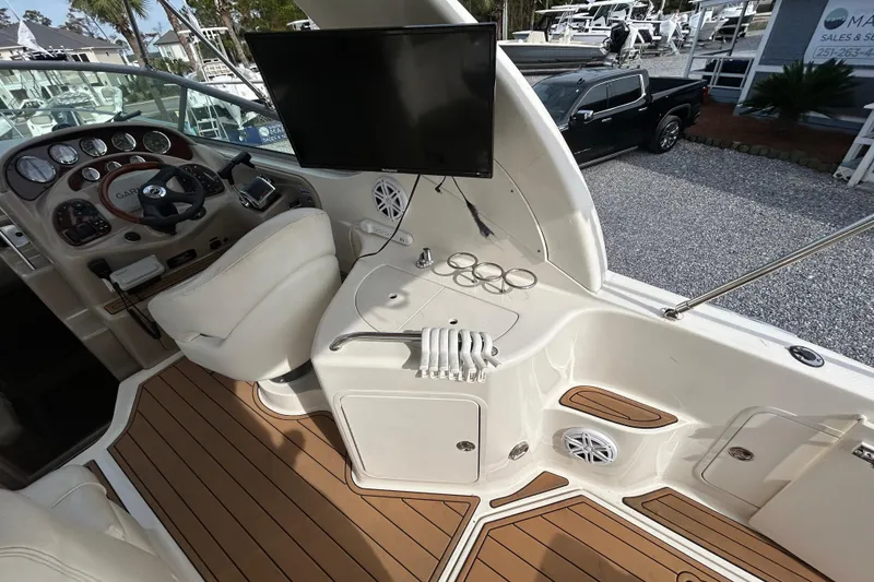 Slide: The Image of 2004 Sea Ray 280 Sundancer cockpit with steering, controls, and seating. - 11