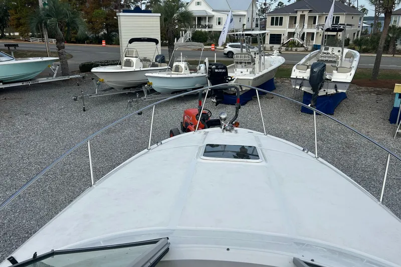 Slide: The Image of 2004 Sea Ray 280 Sundancer in a boatyard with other vessels. - 18