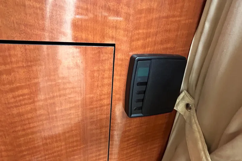 Slide: The Image of Wooden interior panel with control switch on 2004 Sea Ray 280 Sundancer boat. - 23